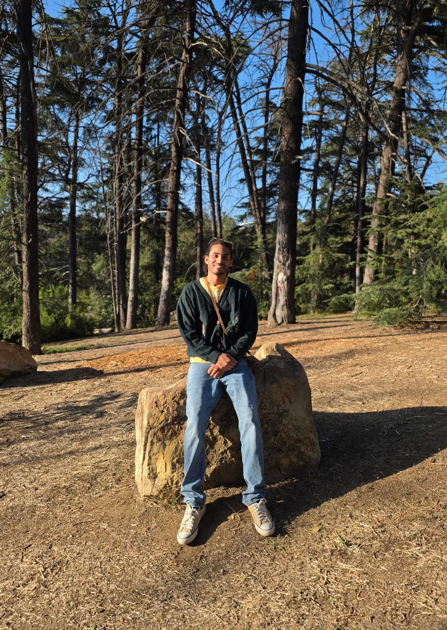 Lorenzo D. Strother, author of Dream of Dreams, seated in a forest